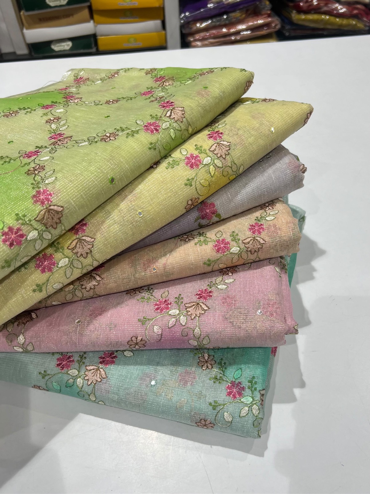 Pastel embroidered sarees at the Peddi's counter
